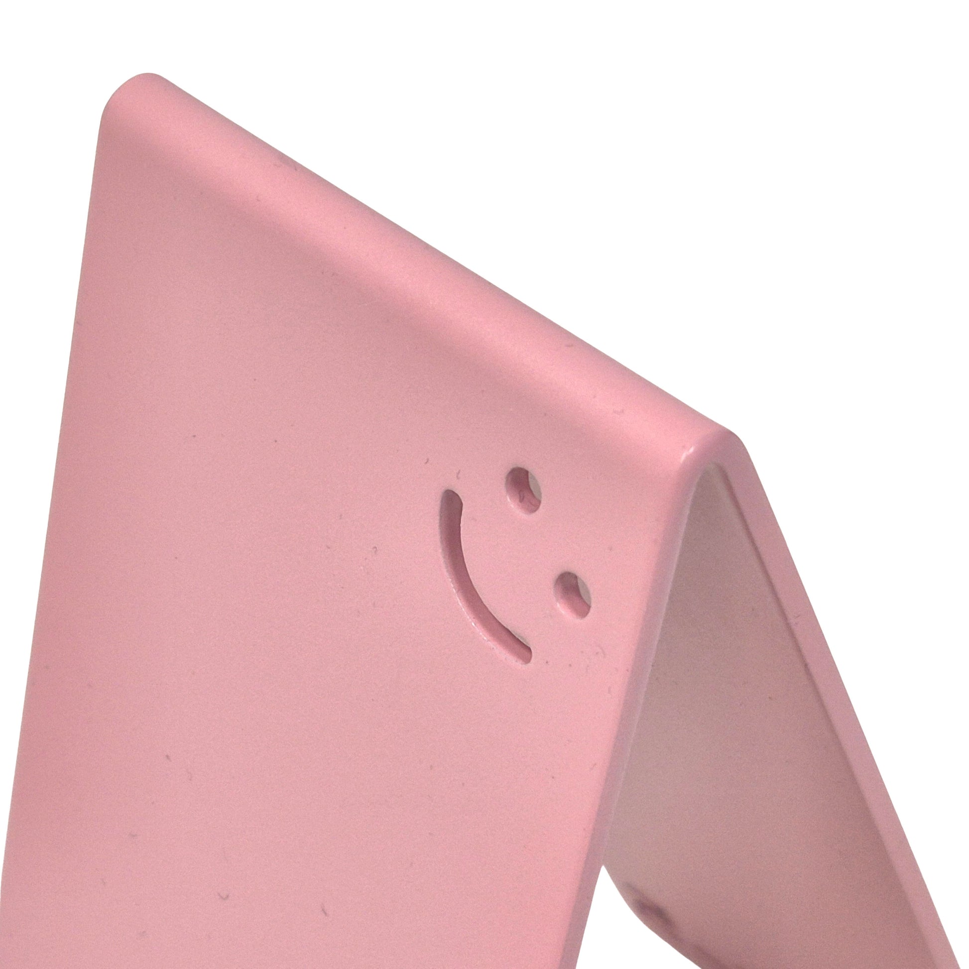 rosa Metall-Handyhalter von Highfive Engineering auf einem Schreibtisch, für ein Smartphone in aufrechter Position Smiley